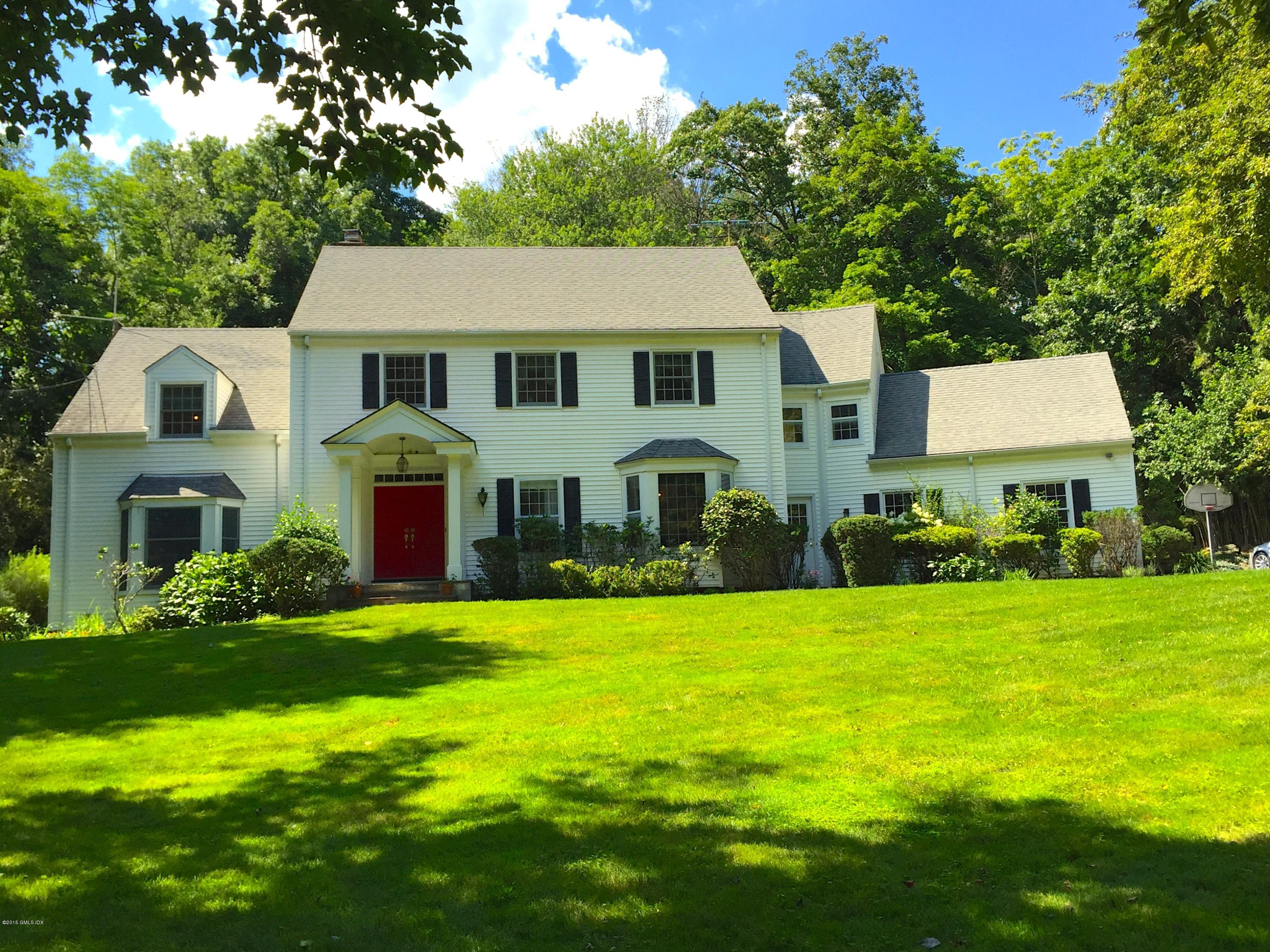 82 Butternut Hollow Road Greenwich, CT 06830 - Photo 29 of 29 a front view of a house with garden and trees