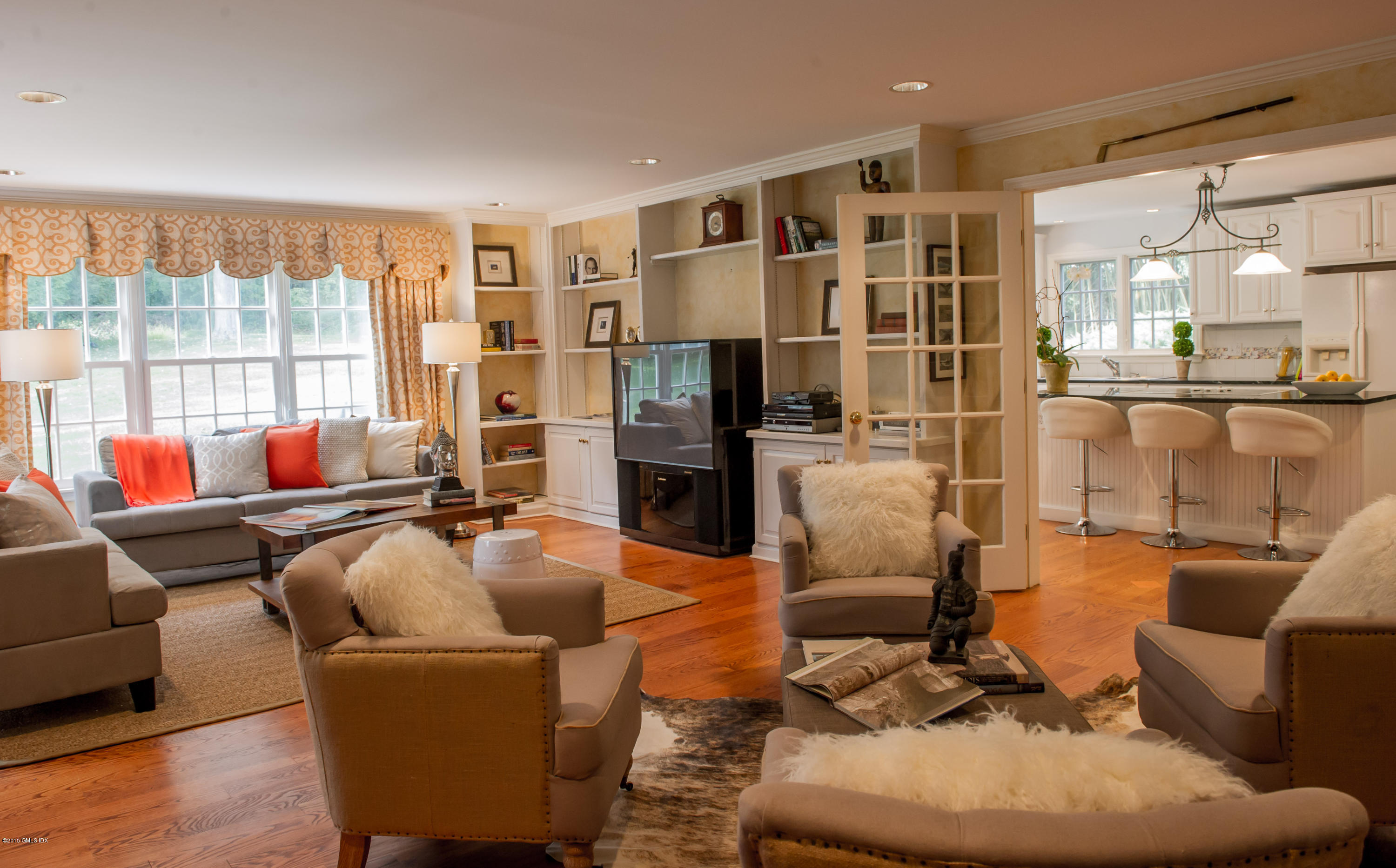 82 Butternut Hollow Road Greenwich, CT 06830 - Photo 8 of 29 a living room with furniture a flat screen tv and a floor to ceiling window