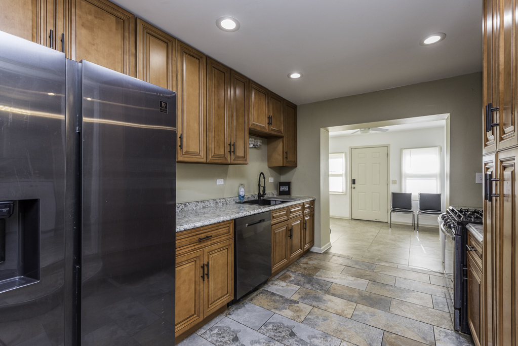 1700 Gideon Avenue Zion, IL 60099 - Photo 12 of 33 a kitchen with stainless steel appliances granite countertop a refrigerator and a sink