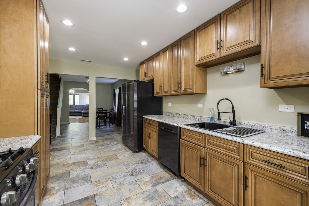 1700 Gideon Avenue Zion, IL 60099 - Photo 13 of 33 a kitchen with stainless steel appliances granite countertop a sink and cabinets