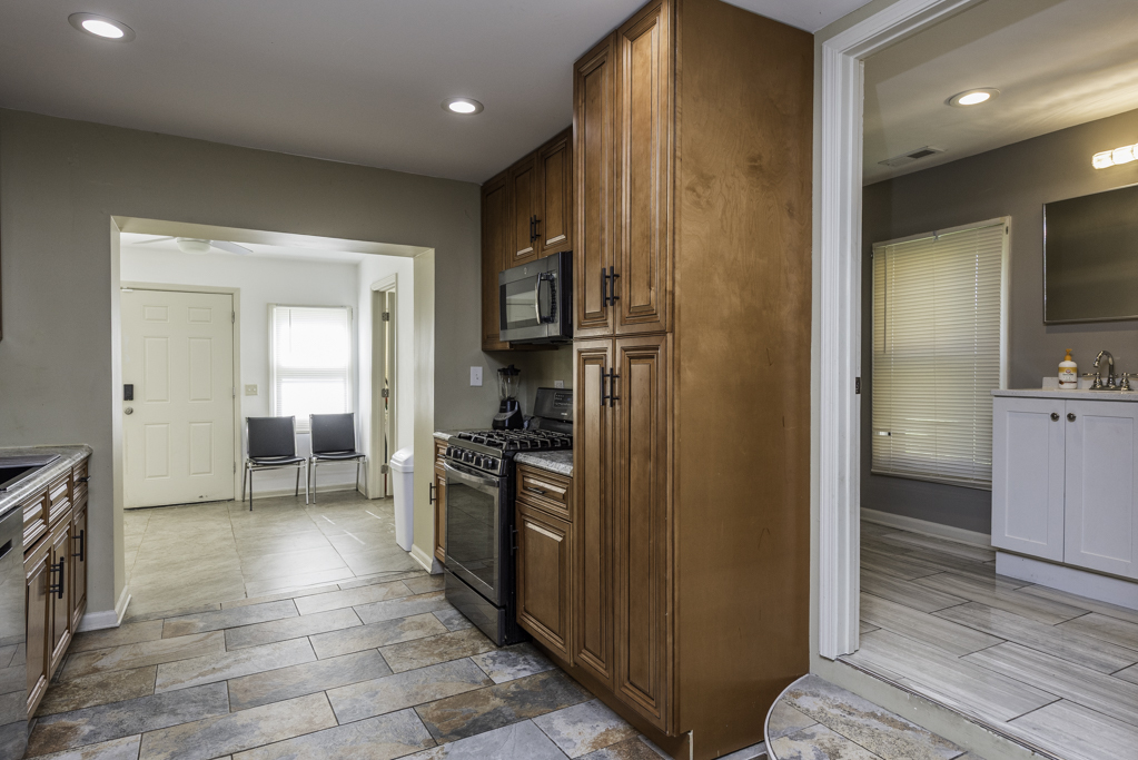 1700 Gideon Avenue Zion, IL 60099 - Photo 15 of 33 a view of a kitchen with a refrigerator a stove top oven and cabinets