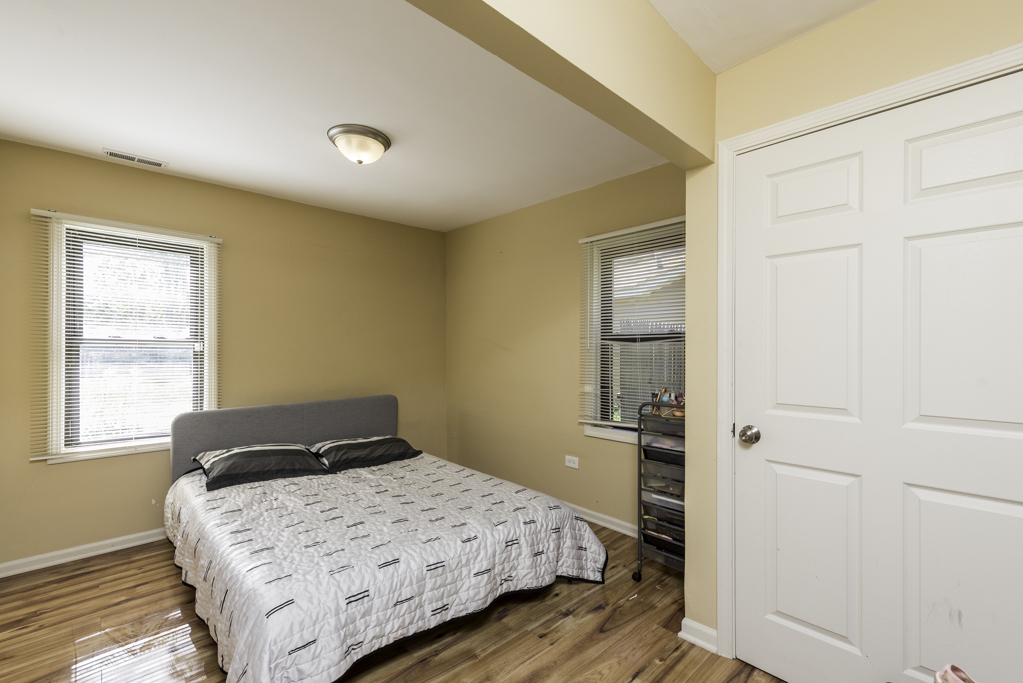 1700 Gideon Avenue Zion, IL 60099 - Photo 29 of 33 a bedroom with a bed and wooden floor