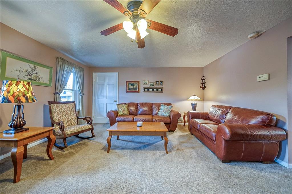 6132 Noblestown Road Oakdale, PA 15071 - Photo 16 of 23 a living room with furniture and a lamp