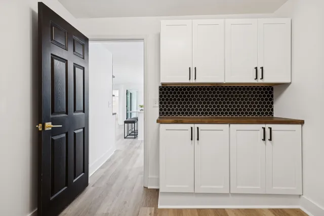 a view of a utility room with wooden floor
