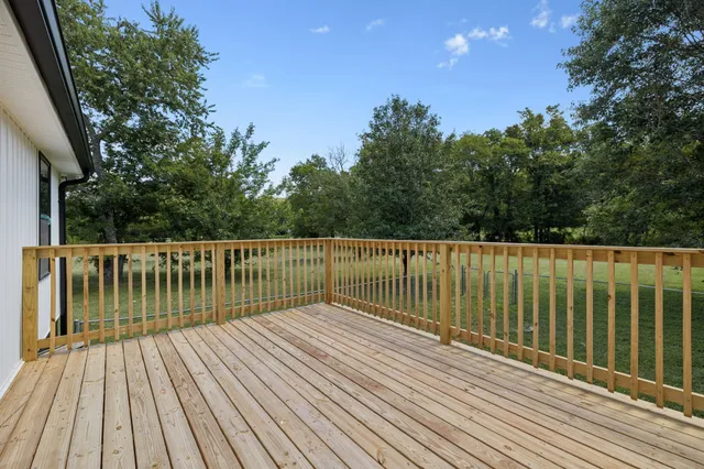 a balcony with wooden floor and fence