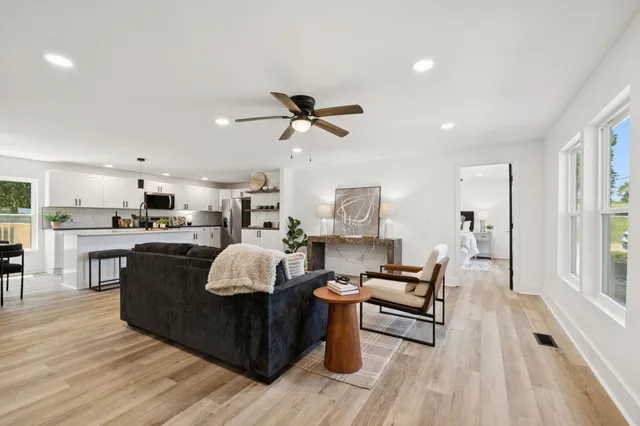 a living room with furniture and a wooden floor