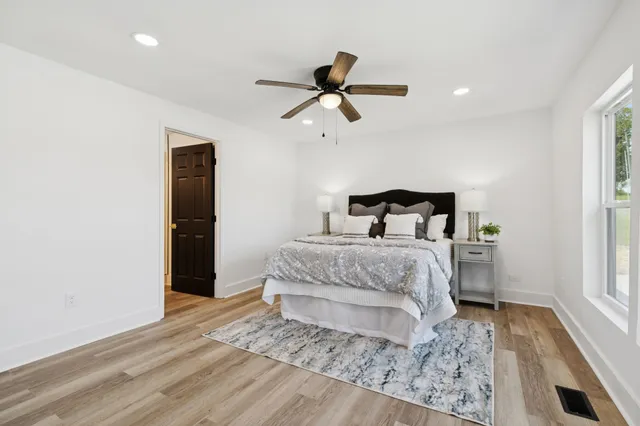 a bedroom with a bed and a window