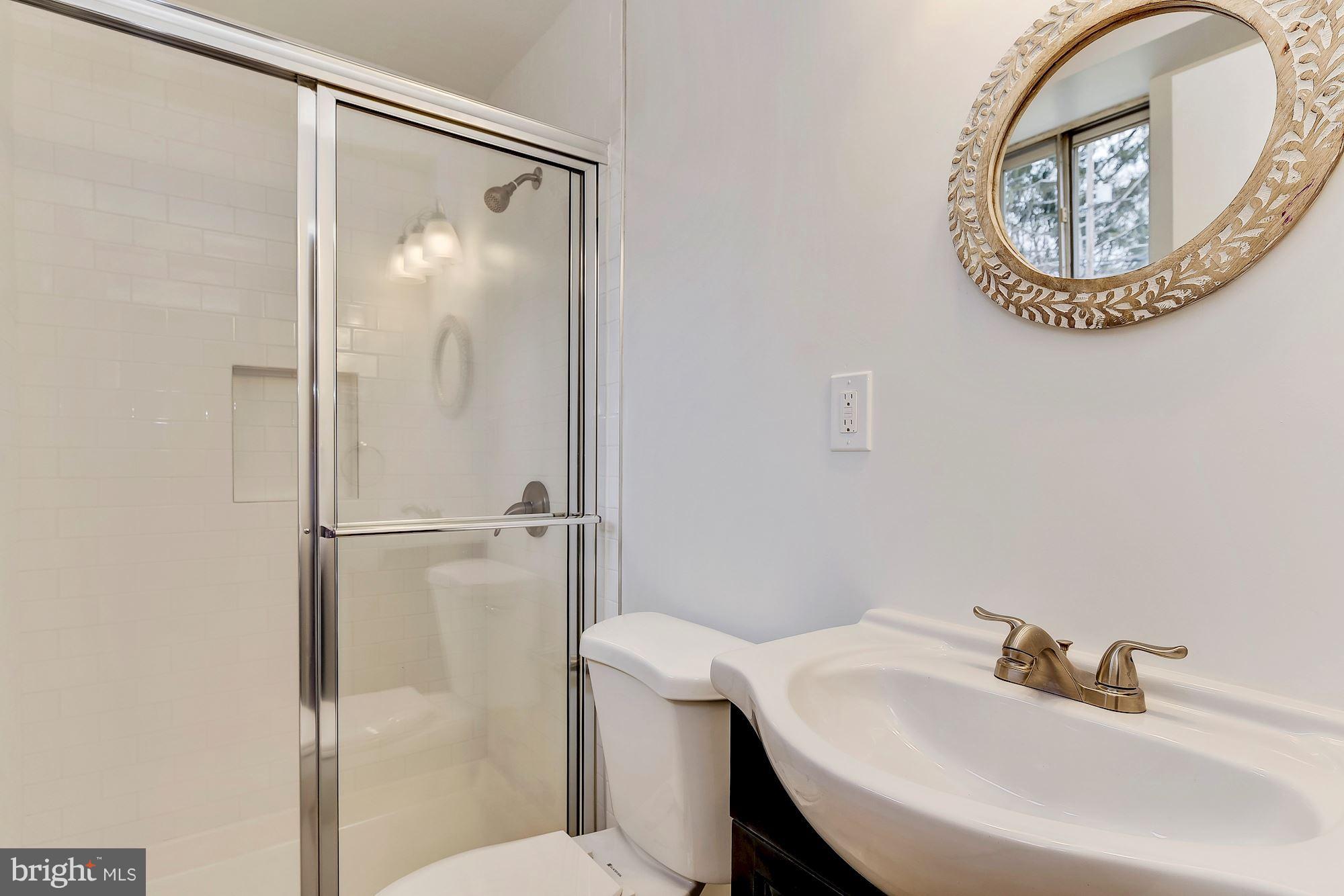 8614 Lugano Road Randallstown, MD 21133 - Photo 22 of 25 a bathroom with a sink and a mirror