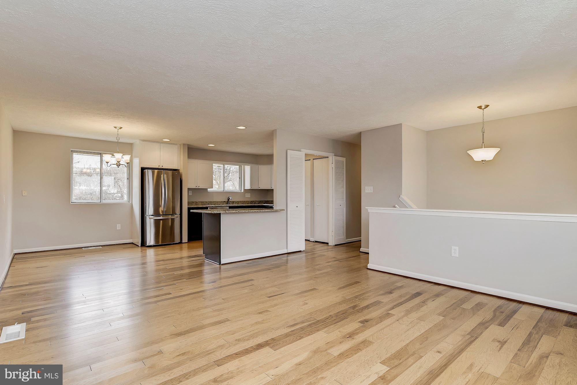 8614 Lugano Road Randallstown, MD 21133 - Photo 4 of 25 a view of kitchen with wooden floor and electronic appliances