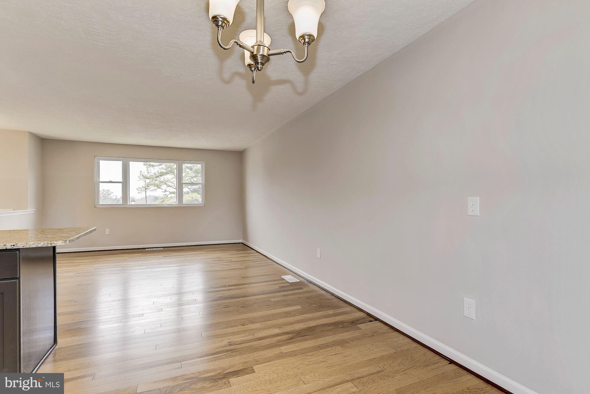 8614 Lugano Road Randallstown, MD 21133 - Photo 8 of 25 a view of a hallway with a window