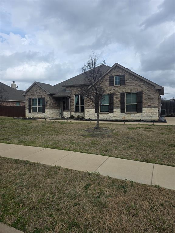 Ranch-style house featuring stone siding