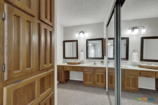 a bathroom with a double vanity sink a mirror and a bathtub