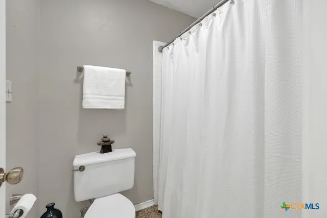 a white toilet sitting next to a small bathroom sink