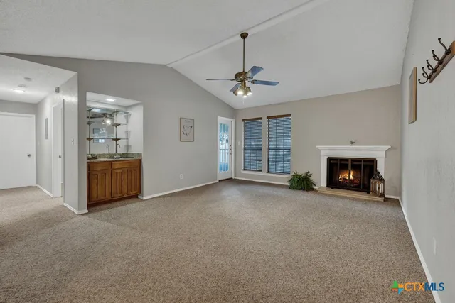 a view of a livingroom with a fireplace and window