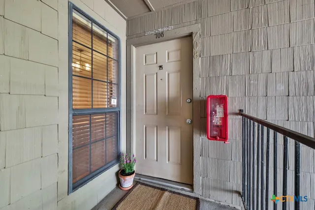 a view of a wooden door with glass door