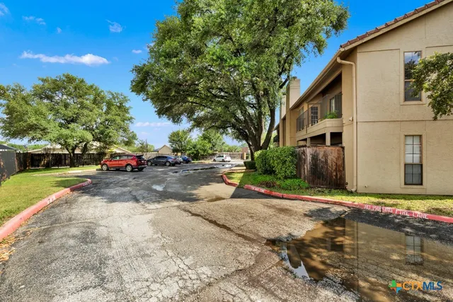 a view of street with parked cars