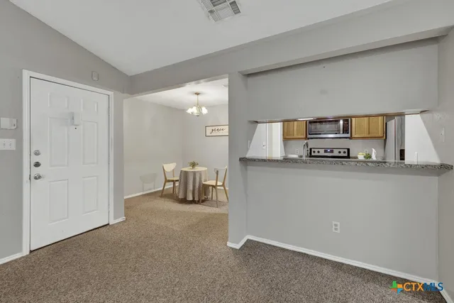 a kitchen with stainless steel appliances a refrigerator and a stove