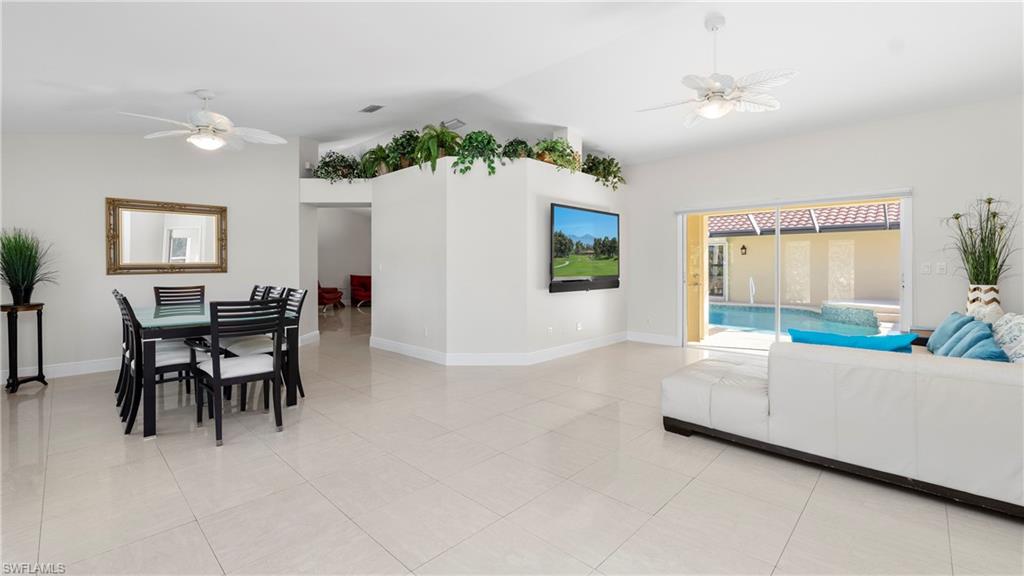 1580 16th Street Northeast Naples, FL 34120 - Photo 12 of 50 a living room with furniture and a chandelier