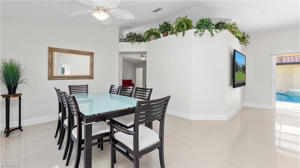 1580 16th Street Northeast Naples, FL 34120 - Photo 13 of 50 a view of a dining room with furniture and a potted plant