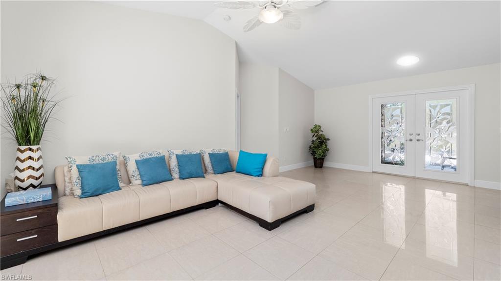 1580 16th Street Northeast Naples, FL 34120 - Photo 16 of 50 a living room with furniture and flowers
