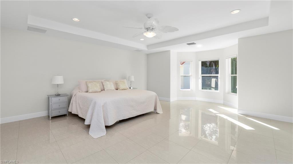 1580 16th Street Northeast Naples, FL 34120 - Photo 17 of 50 a bedroom with a bed and a large window