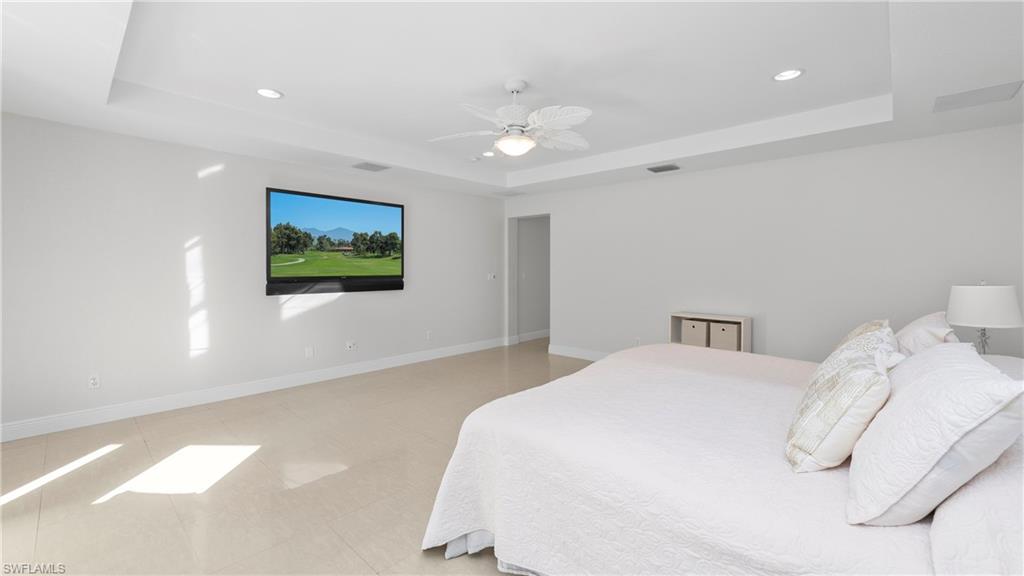 1580 16th Street Northeast Naples, FL 34120 - Photo 18 of 50 a bedroom with a bed and a flat screen tv