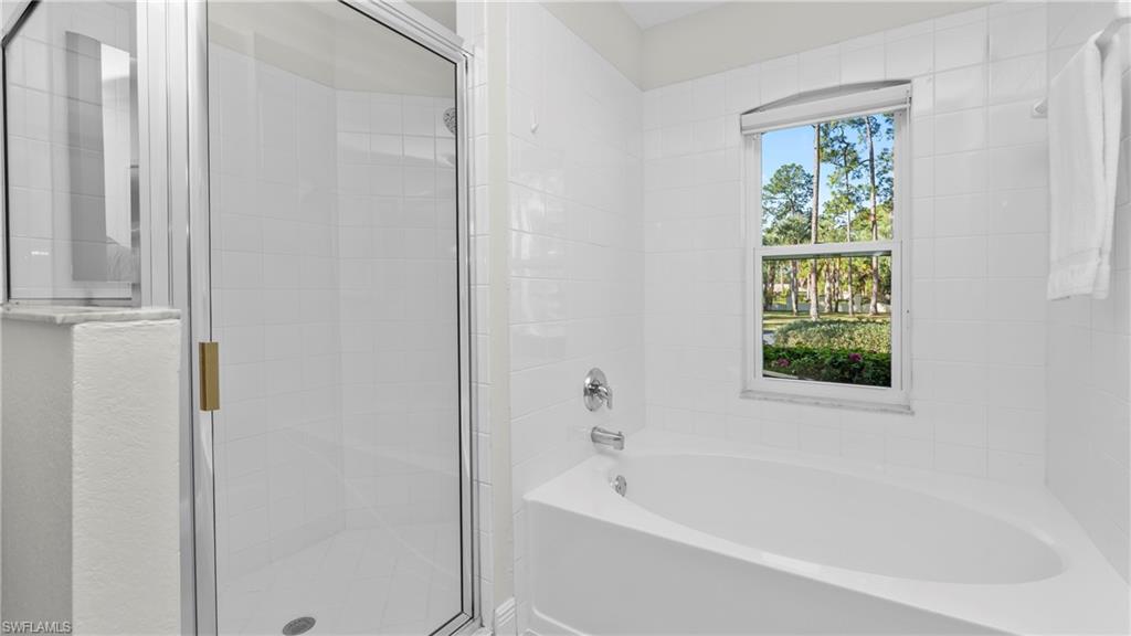 1580 16th Street Northeast Naples, FL 34120 - Photo 32 of 50 a white bath tub sitting next to a window