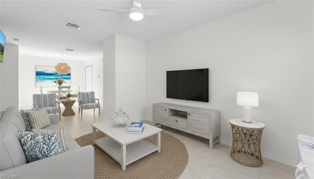 1580 16th Street Northeast Naples, FL 34120 - Photo 38 of 50 a living room with furniture and a flat screen tv