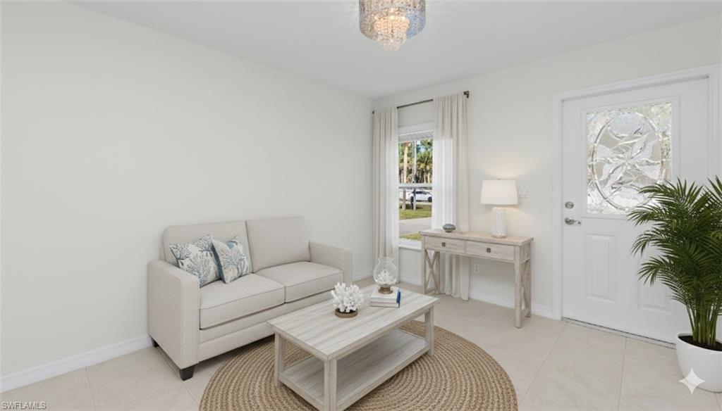 1580 16th Street Northeast Naples, FL 34120 - Photo 39 of 50 a living room with furniture and a large window