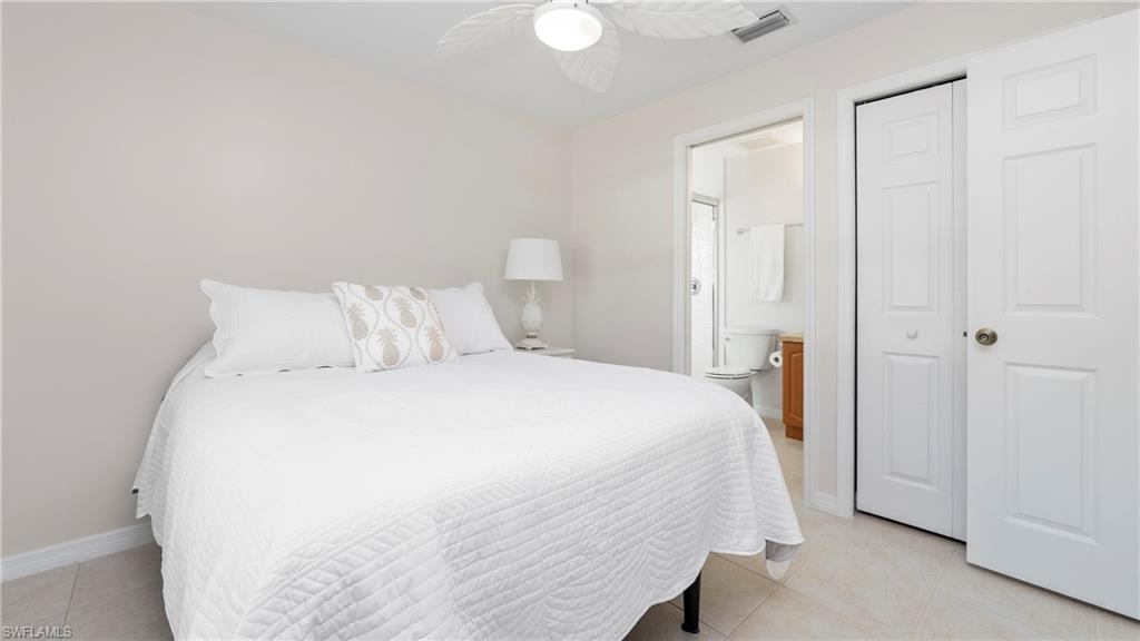 1580 16th Street Northeast Naples, FL 34120 - Photo 43 of 50 a bedroom with a bed and a closet