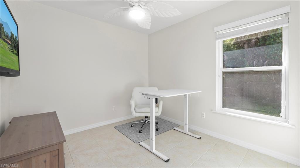 1580 16th Street Northeast Naples, FL 34120 - Photo 45 of 50 a room with a window and a chair