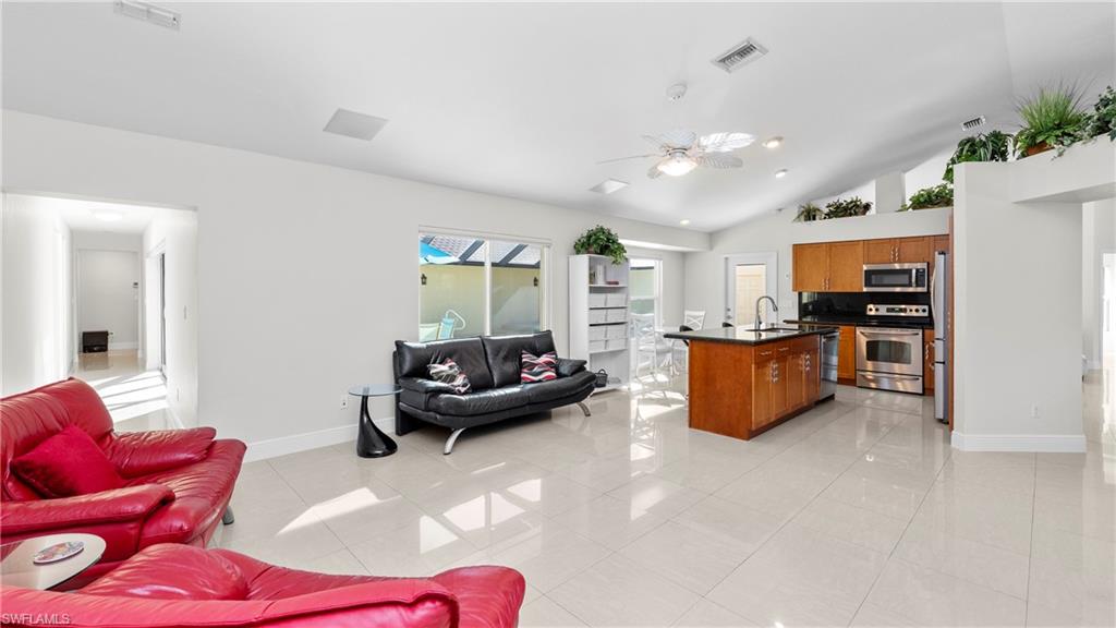1580 16th Street Northeast Naples, FL 34120 - Photo 8 of 50 a living room with furniture kitchen view and a chandelier