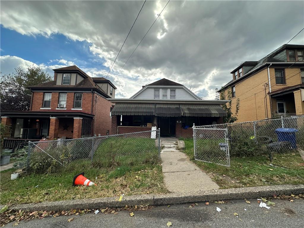 516 Cathedral Avenue Pittsburgh, PA 15210 - Photo 4 of 6 a front view of a house with a yard