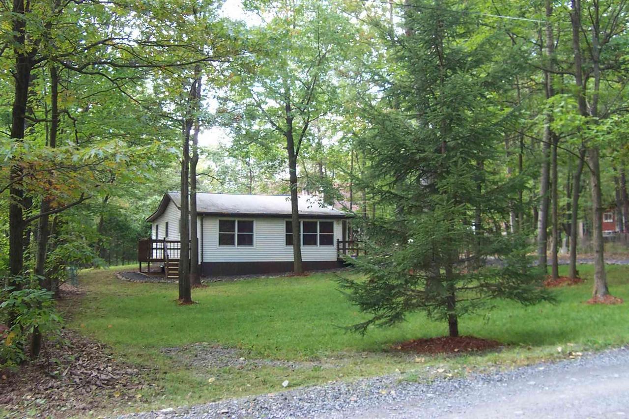 1706 Valley Road Effort, PA 18330 - Photo 1 of 15 a view of a house with backyard garden and trees