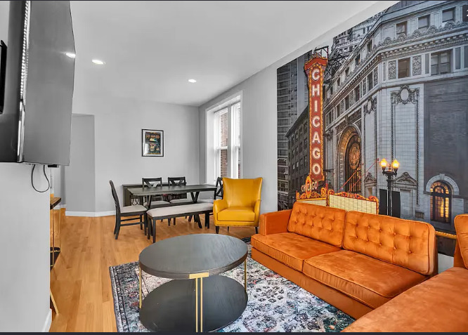 448 North Aberdeen Street, Unit 2 Chicago, IL 60642 - Photo 2 of 10 a living room with furniture a rug and a lamp