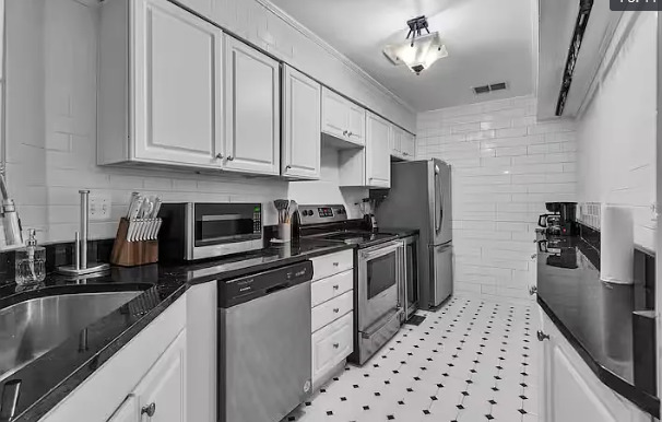 448 North Aberdeen Street, Unit 2 Chicago, IL 60642 - Photo 4 of 10 a kitchen with stainless steel appliances a refrigerator a sink a stove and white cabinets