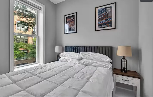 448 North Aberdeen Street, Unit 2 Chicago, IL 60642 - Photo 8 of 10 a large bed sitting in a bedroom next to a window