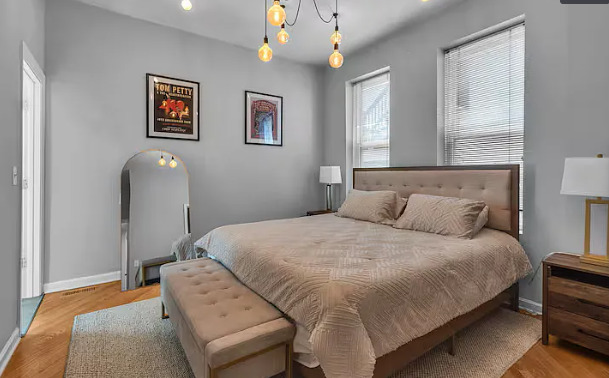 448 North Aberdeen Street, Unit 2 Chicago, IL 60642 - Photo 9 of 10 a bedroom with a bed and a painting on the wall