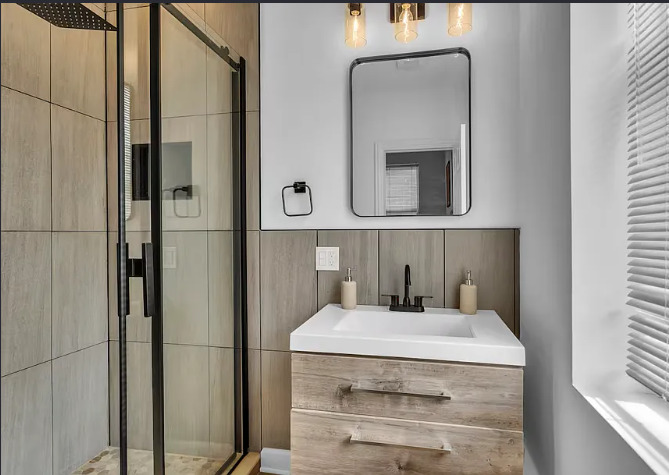 448 North Aberdeen Street, Unit 2 Chicago, IL 60642 - Photo 10 of 10 a bathroom with a sink and mirror