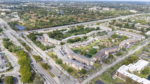an aerial view of a residential houses with outdoor space
