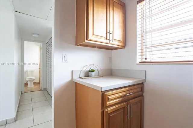 a view of a kitchen that shows a sink washer and dryer