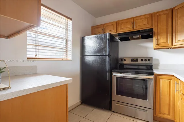 a kitchen with a refrigerator sink and stove
