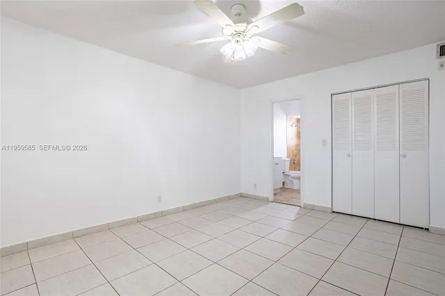 an empty room with chandelier fan