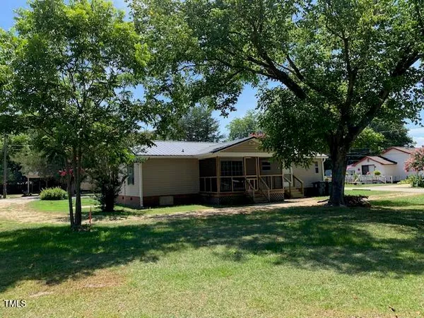 a view of a house with a yard and tree