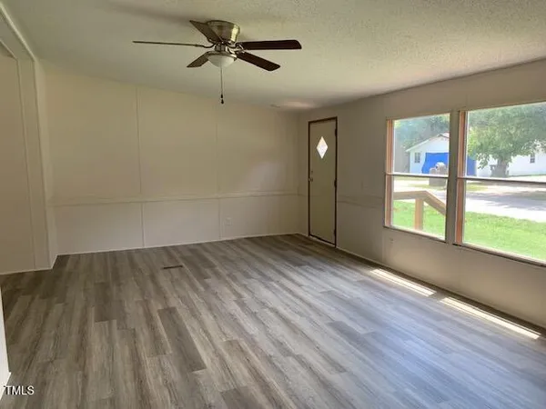 wooden floor in an empty room with a window