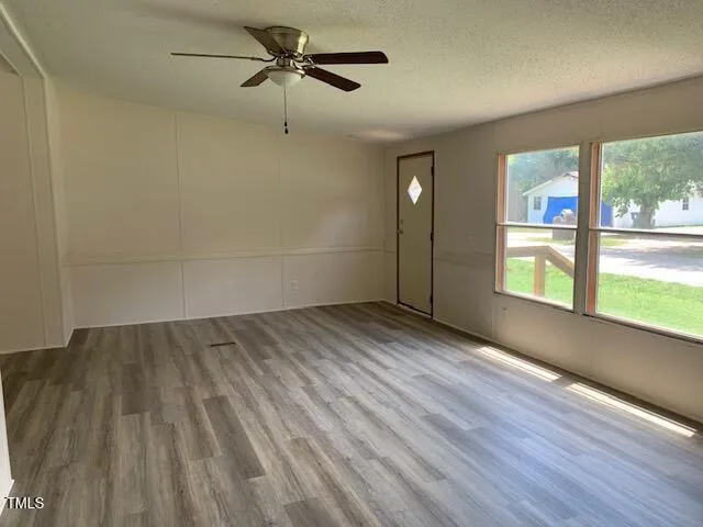 wooden floor in an empty room with a window