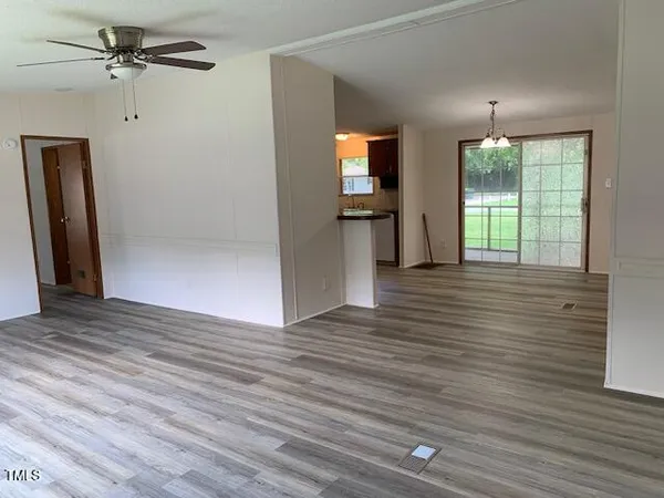 wooden floor in an empty room with a window