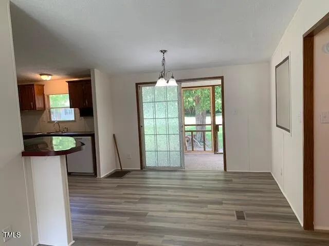 a view of entryway and hall with wooden floor