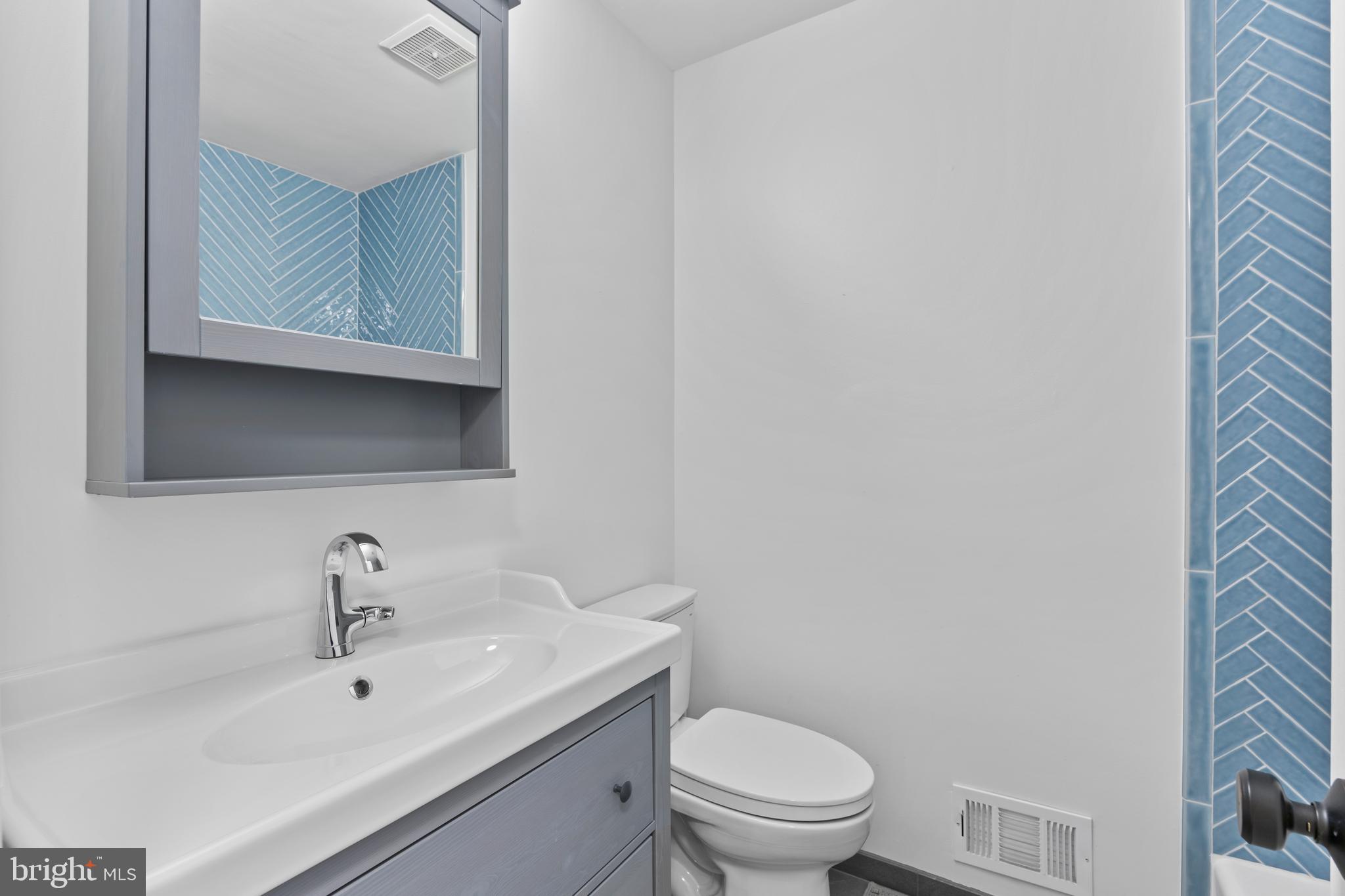 11019 Ring Road Reston, VA 20190 - Photo 51 of 78 a bathroom with a toilet a sink and mirror