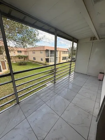 a view of a porch with wooden floor and stairs